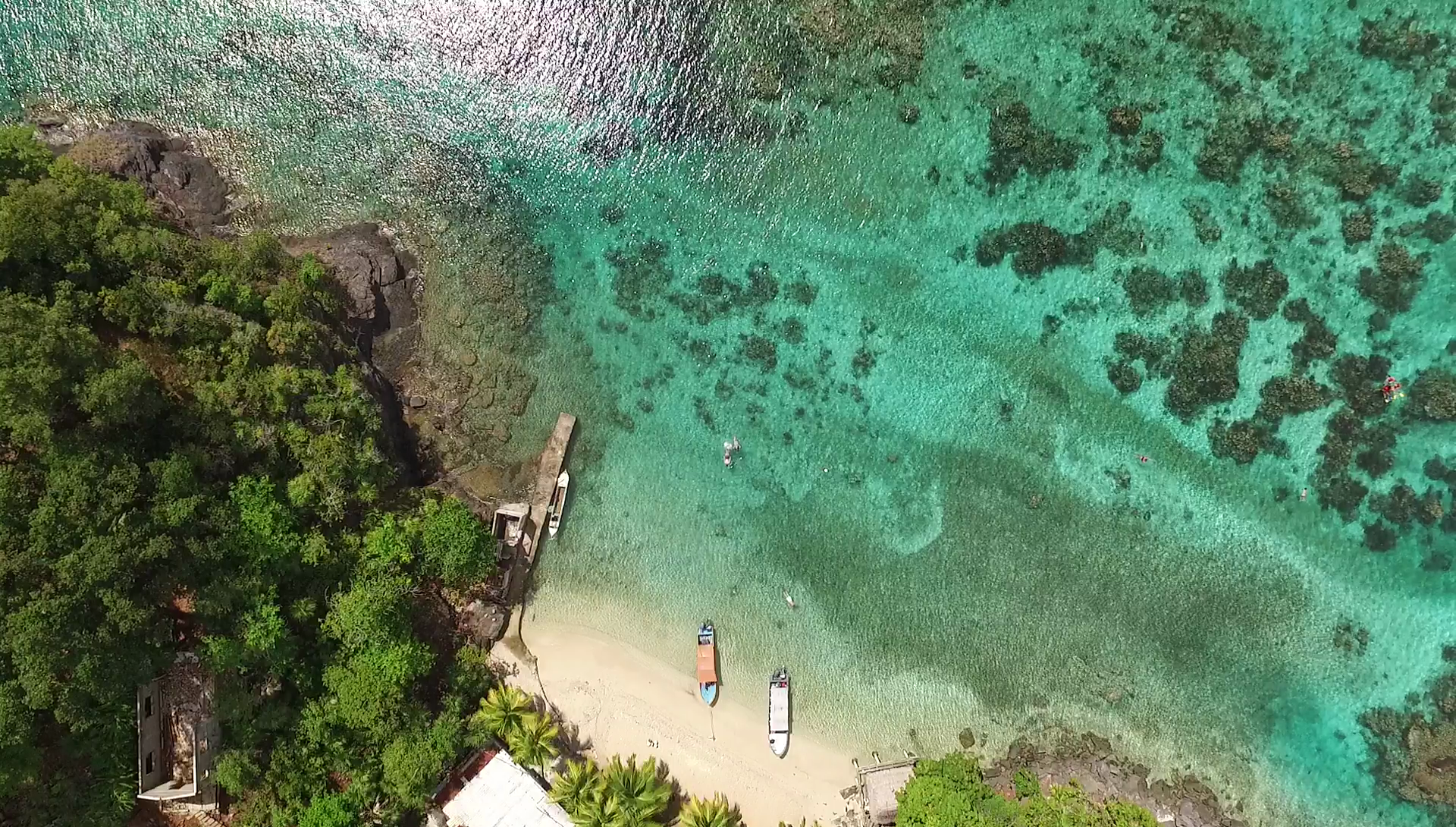 Aerial view of Cayos Cochinos turquoise waters and tropical island, Honduras